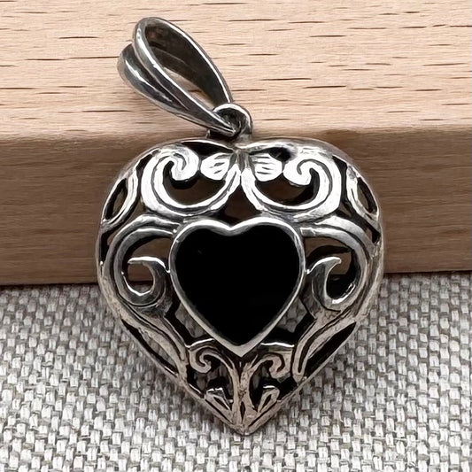 Dual heart-shaped pendant with black onyx stones