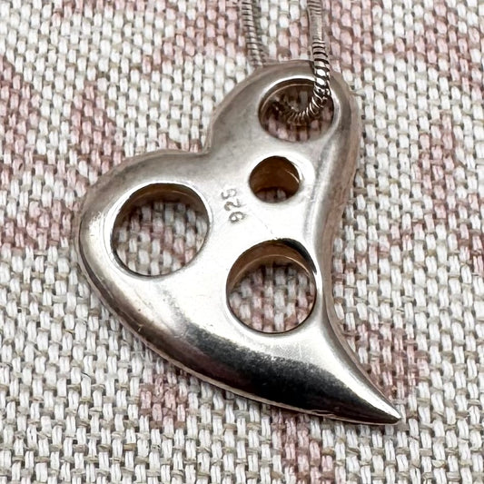 Asymmetrical silver heart pendant with cut-out details