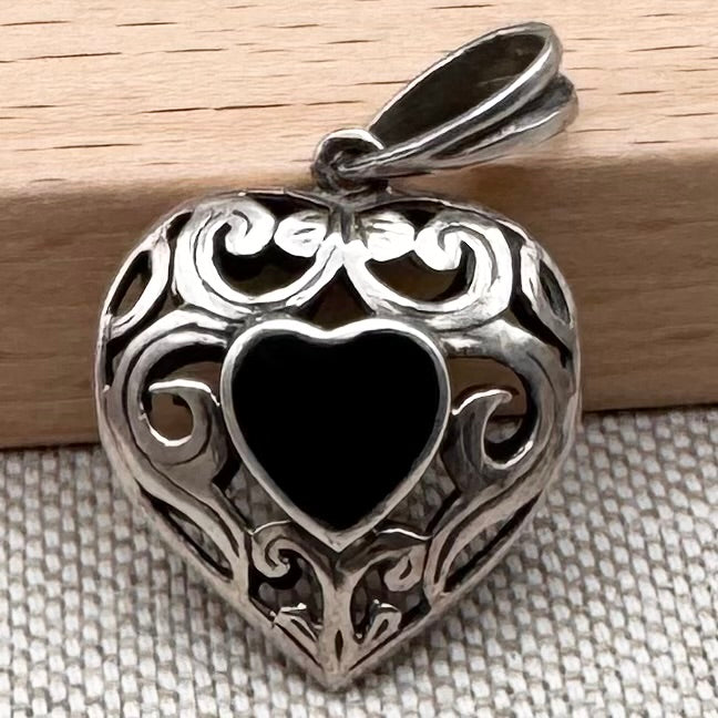 Dual heart-shaped pendant with black onyx stones