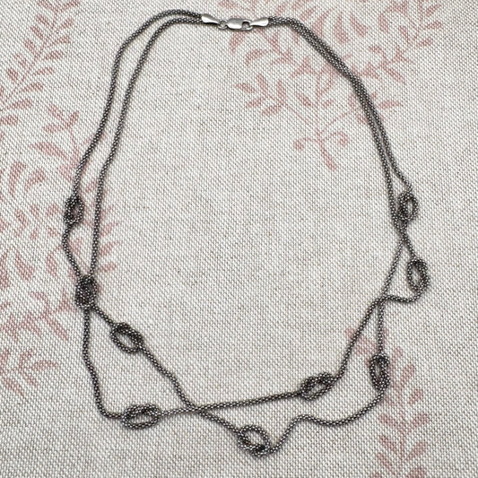 Necklace on a textured fabric background