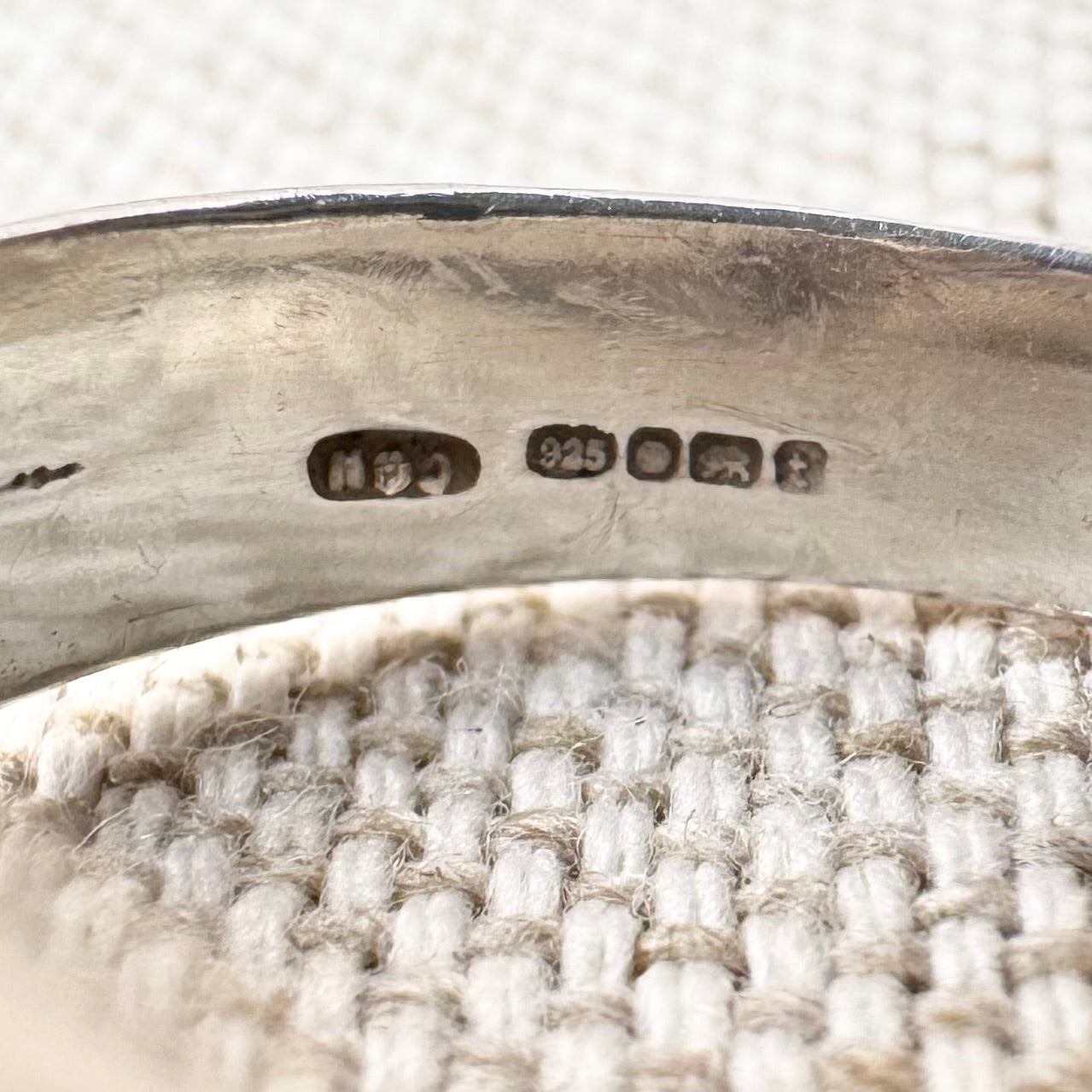 Close-up view of the hallmarks of a silver ring