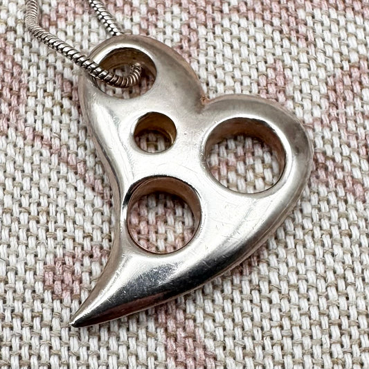 Asymmetrical silver heart pendant with cut-out details