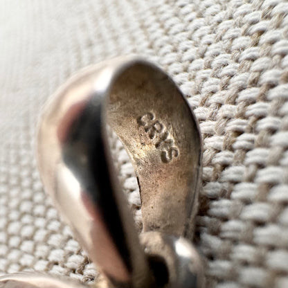 Carved rose quartz pendant in silver setting