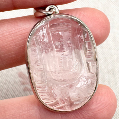 Carved rose quartz pendant in silver setting