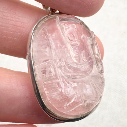 Carved rose quartz pendant in silver setting