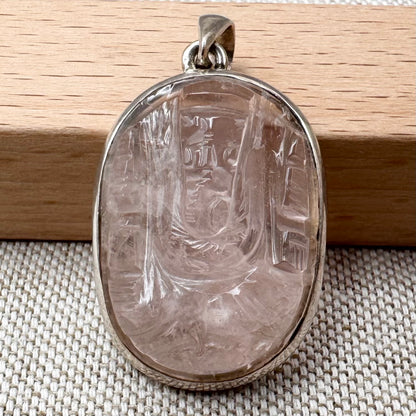Carved rose quartz pendant in silver setting