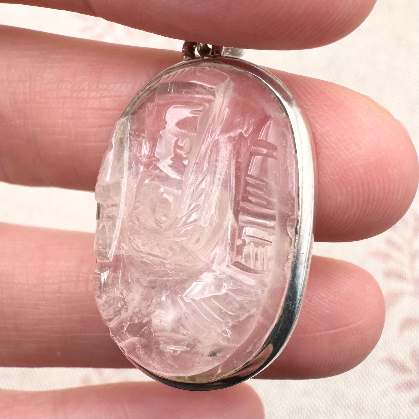 Carved rose quartz pendant in silver setting