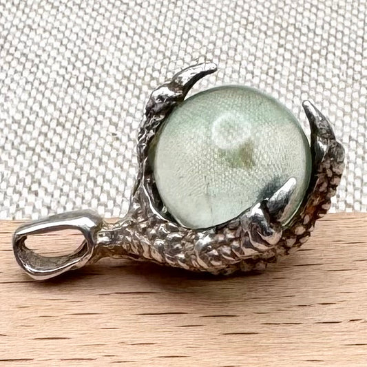 Silver pendant with pale green glass sphere
