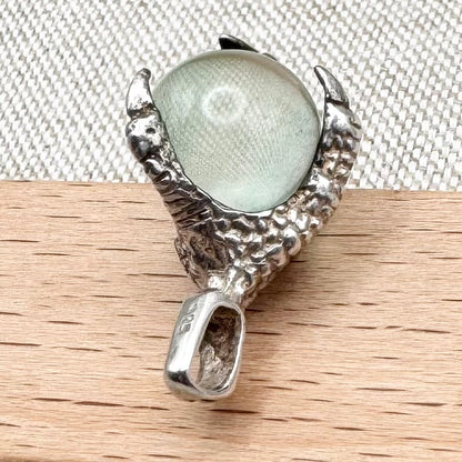 Silver pendant with pale green glass sphere