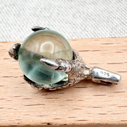 Silver pendant with pale green glass sphere