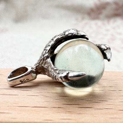 Silver pendant with pale green glass sphere