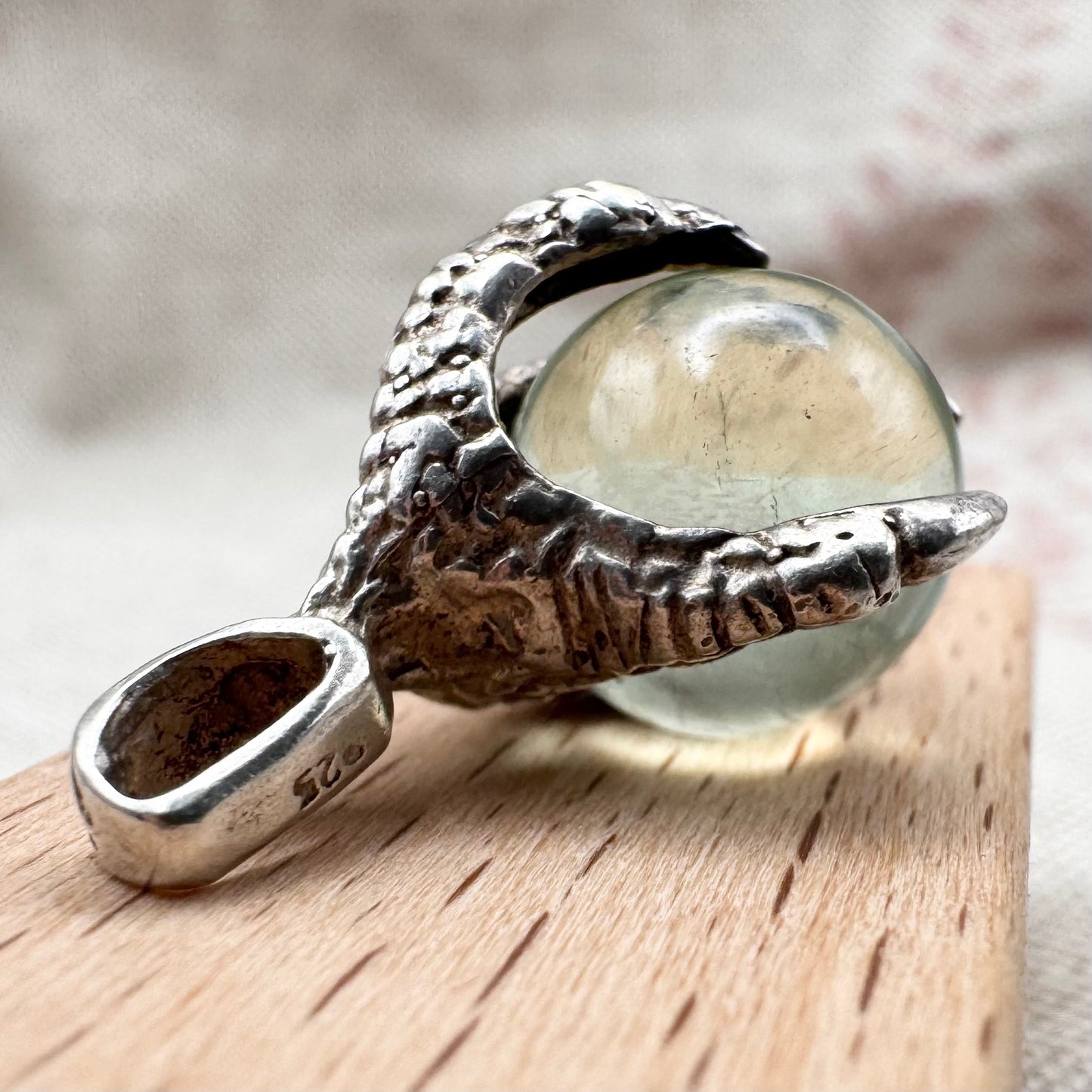 Silver pendant with pale green glass sphere