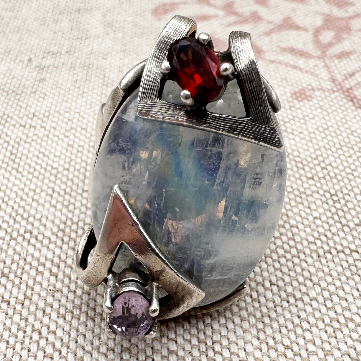 Silver moonstone ring with lilac and red stone accents, size R.5 (US 9)