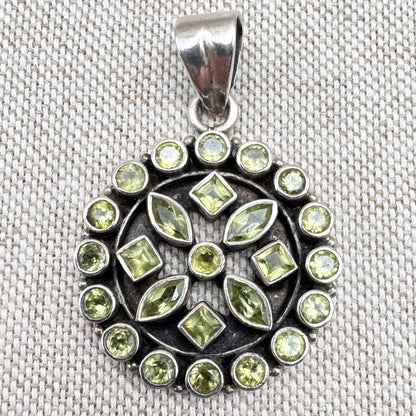 Silver peridot pendant in a circular floral cluster design
