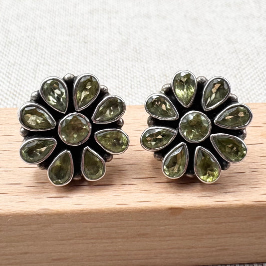Silver peridot stud earrings in a floral cluster design