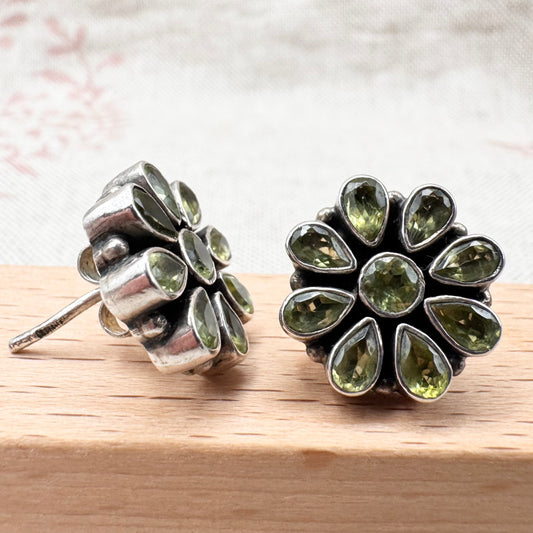Silver peridot stud earrings in a floral cluster design