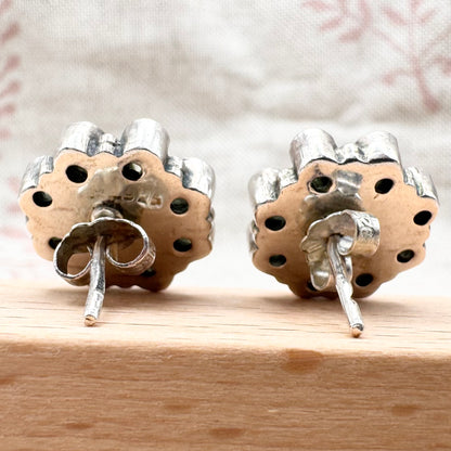 Silver peridot stud earrings in a floral cluster design