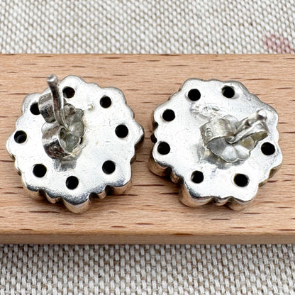 Silver peridot stud earrings in a floral cluster design