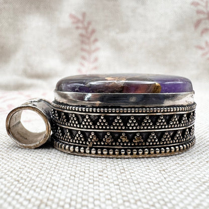 Chunky silver pendant with purple composite stone