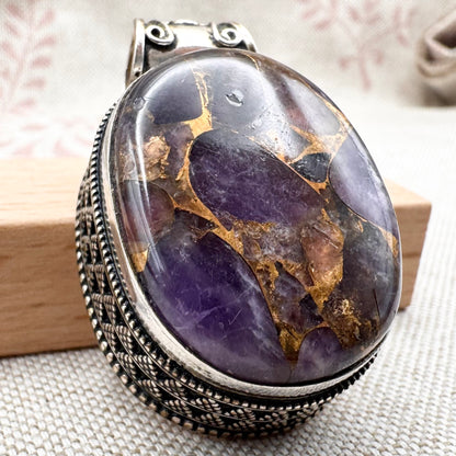 Chunky silver pendant with purple composite stone