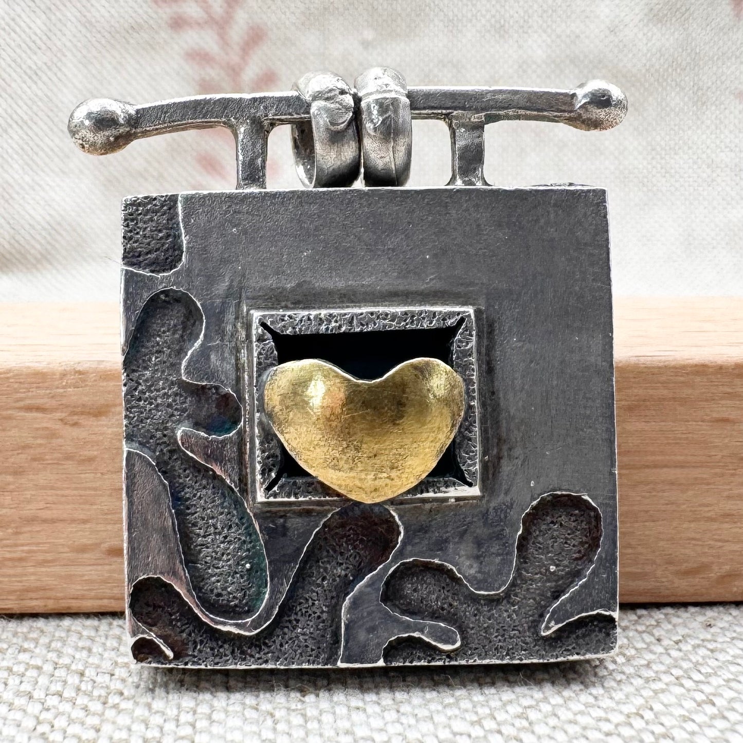 Vintage artisan silver pendant with heart detail