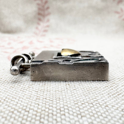 Vintage artisan silver pendant with heart detail