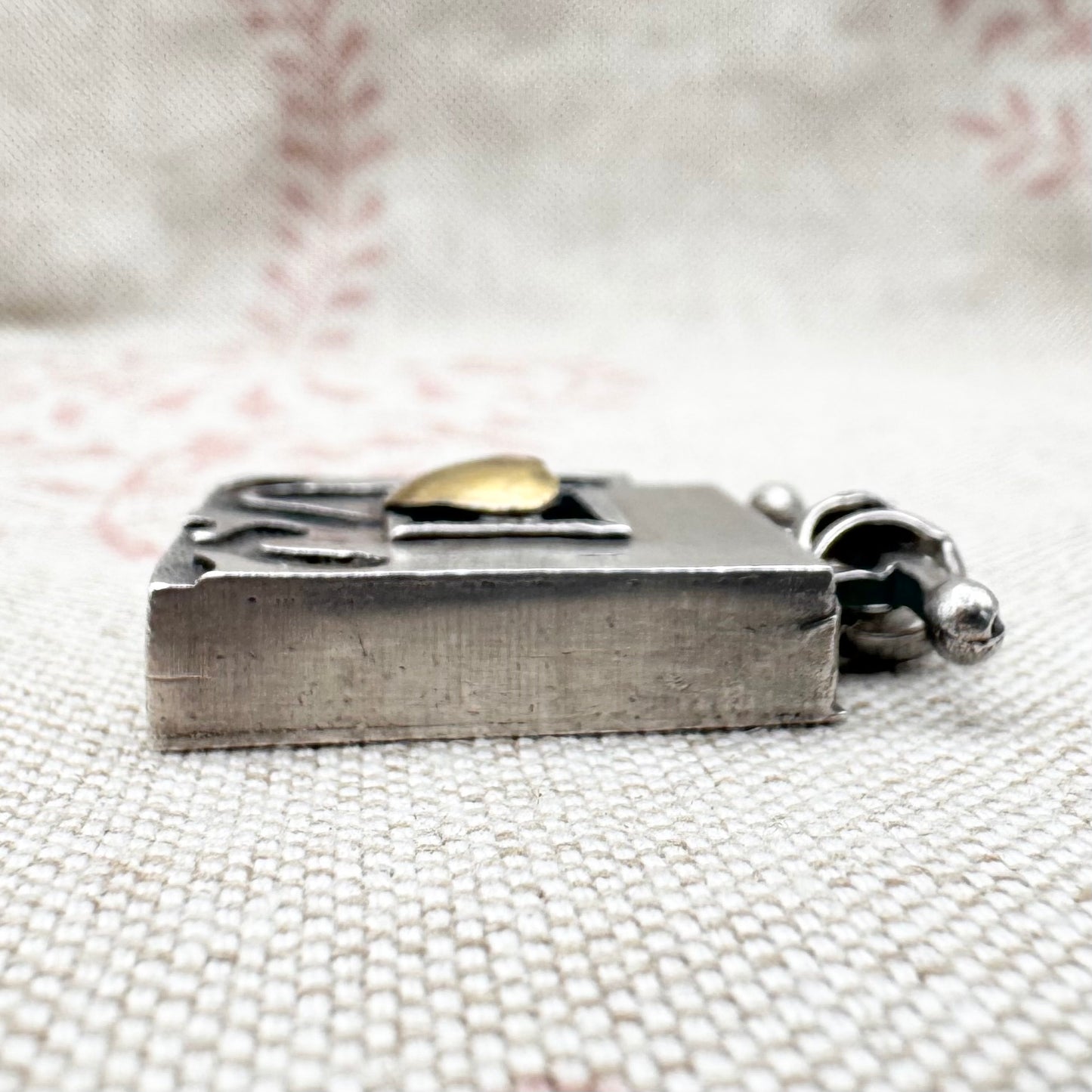 Vintage artisan silver pendant with heart detail