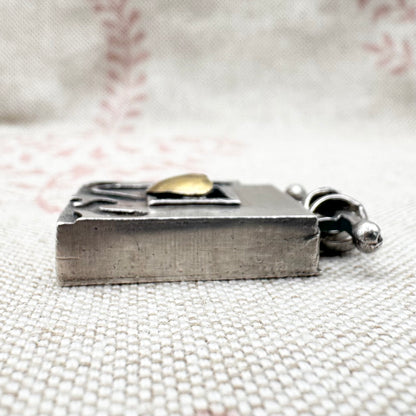 Vintage artisan silver pendant with heart detail