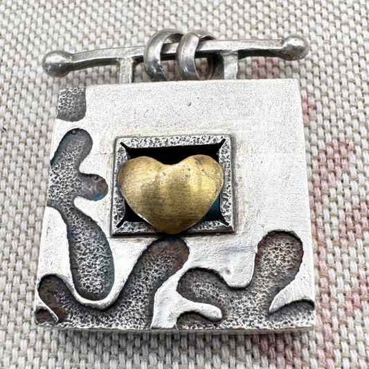 Vintage artisan silver pendant with heart detail