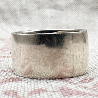 Silver ring on a textured fabric background