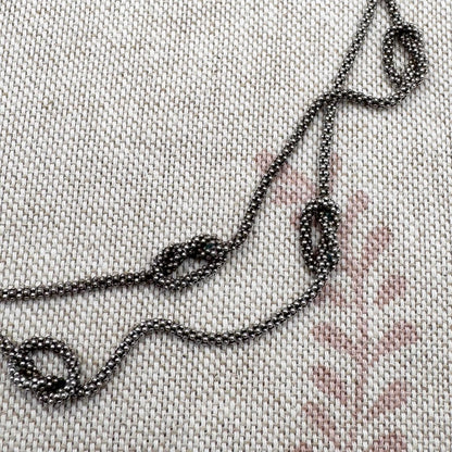 Close-up of embroidered chain on fabric