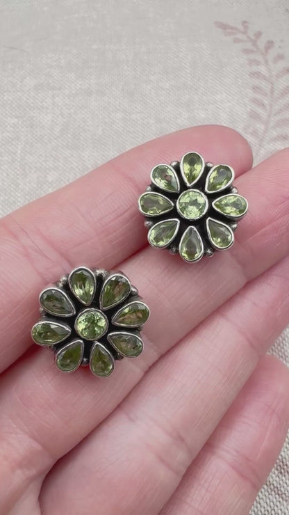 Silver peridot stud earrings in a floral cluster design