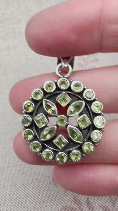 Silver peridot pendant in a circular floral cluster design