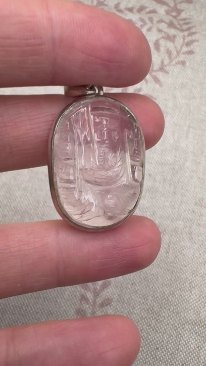 Carved rose quartz pendant in silver setting