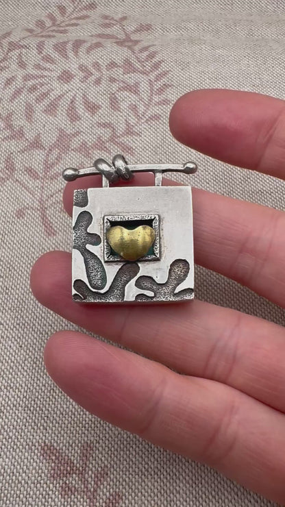 Vintage artisan silver pendant with heart detail